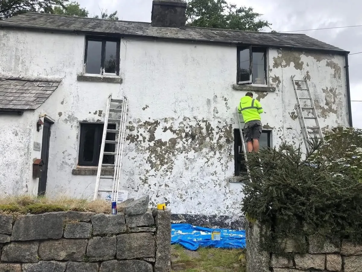 Cottage with blown, flaking render before repair in Bude